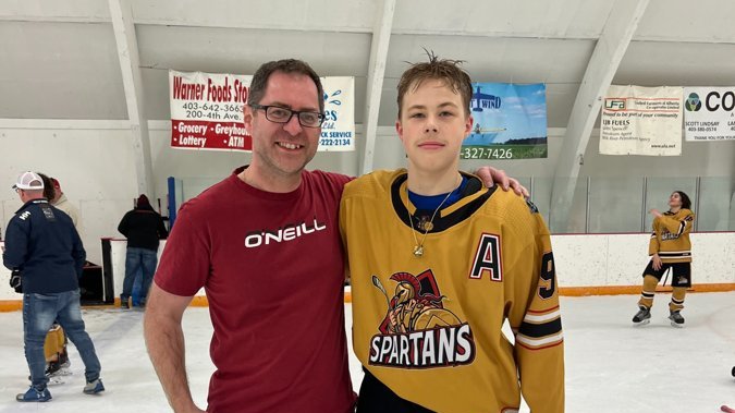 Matthew Birch with his son Brendan on the ice after the Spartans' 2023 PHL Championship win—highlighting how finding the right fit matters in hockey, surgery, and bookkeeping.